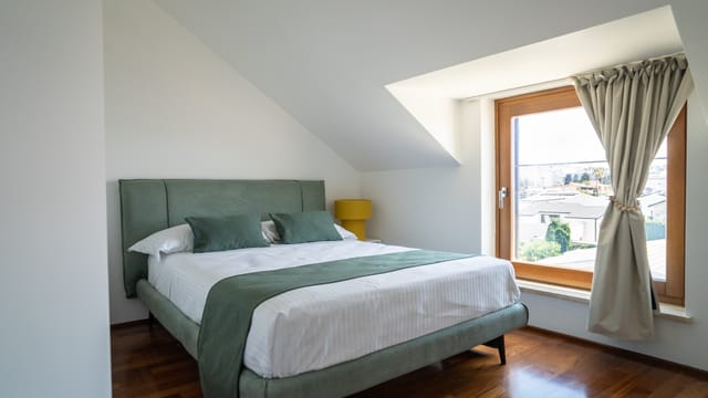 La seconda camera da letto con testiera verde salvia